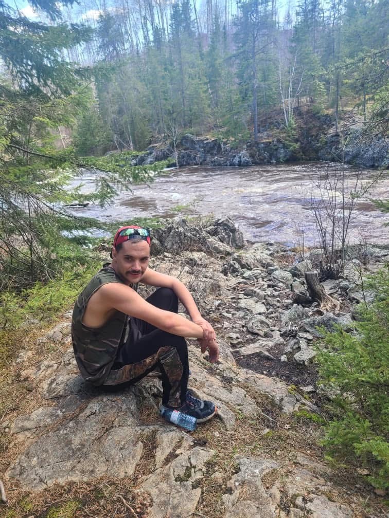 a man sitting in a forest